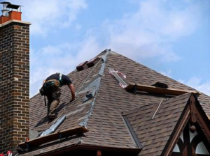 Residential roof being replaced with new shingles by a professional