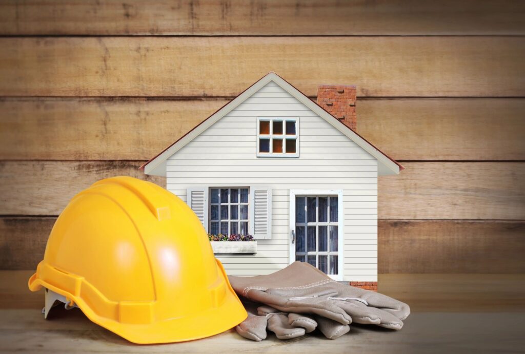 Small home with gloves and a hard hat next to it